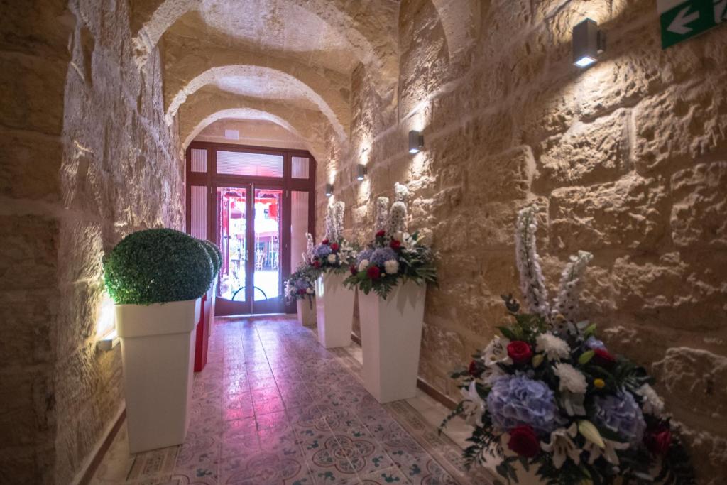 a hallway with flowers and plants in a stone wall at 39 St. George in Victoria