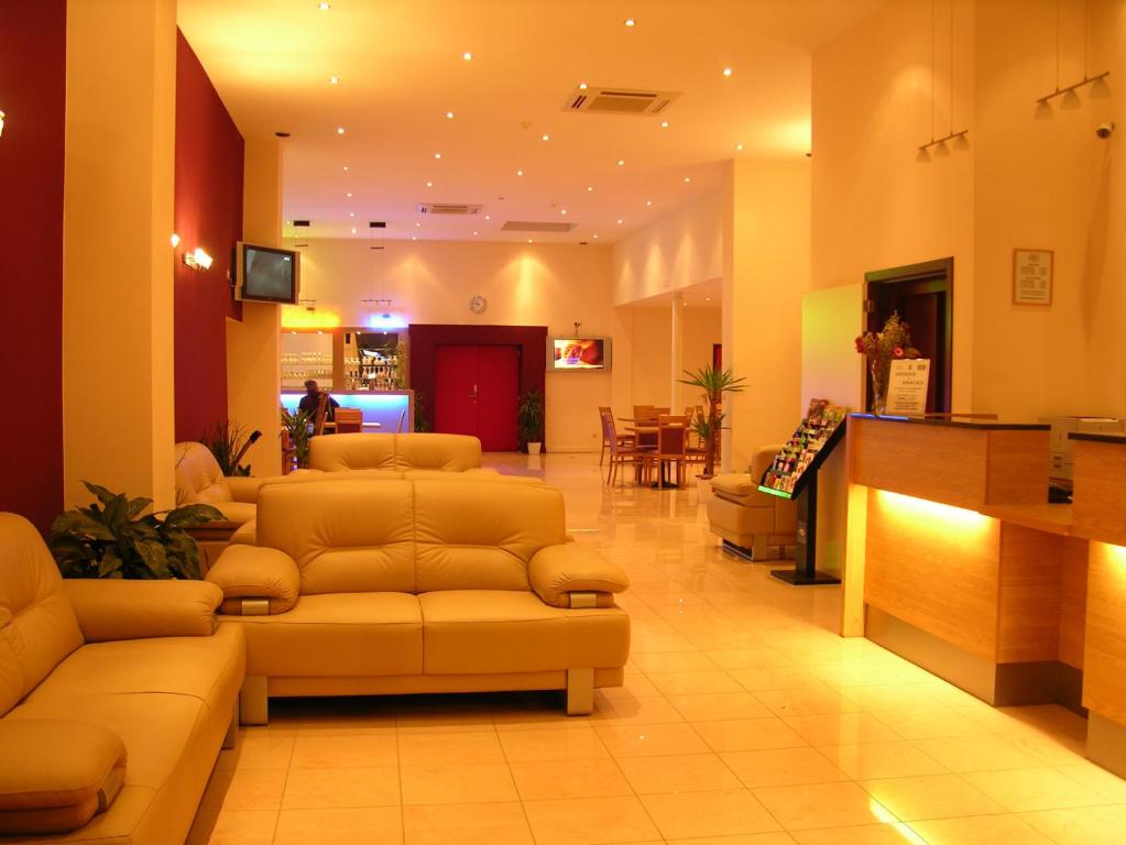 a lobby with couches and a bar in a hospital at Hotel Euro Capital Brussels in Brussels