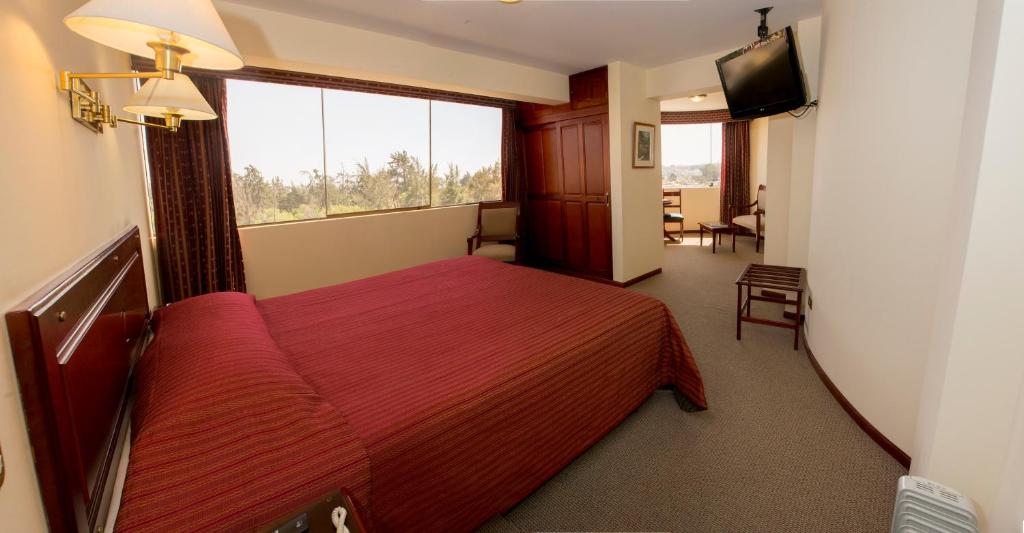 El Cabildo Hotel tesisinde bir odada yatak veya yataklar