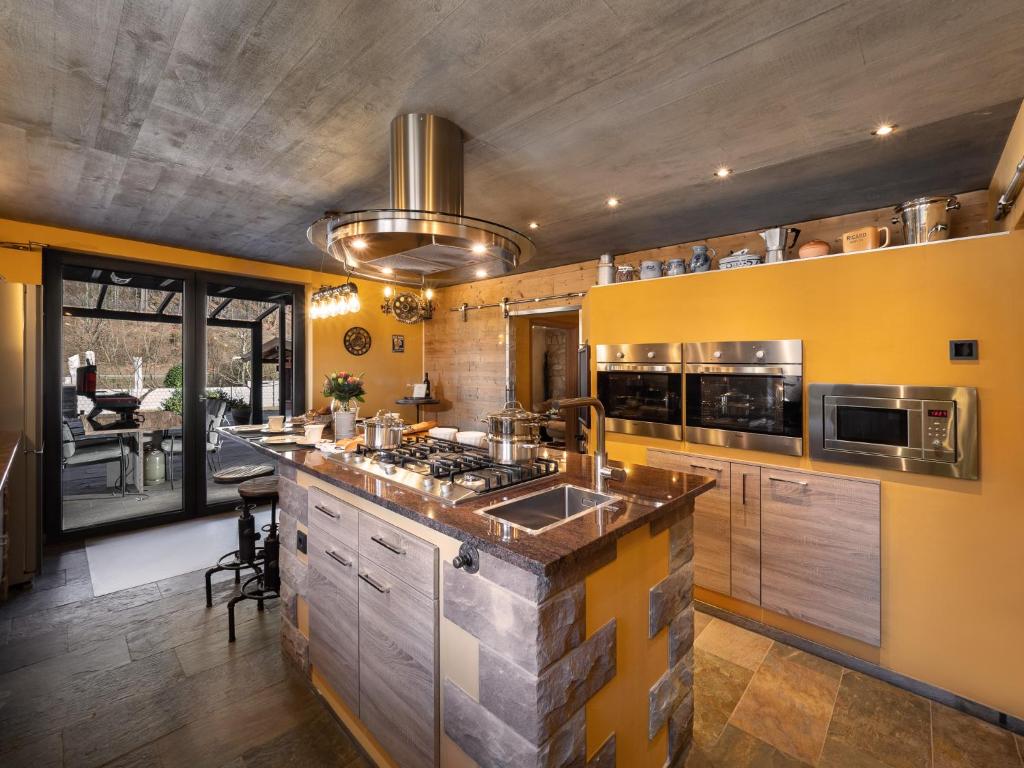 a kitchen with a stove top oven next to a counter at Ferienwohnung Altschloss in Eppenbrunn