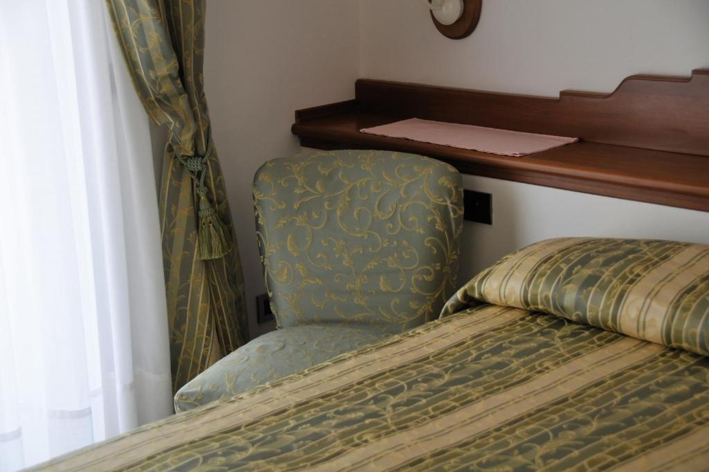 Postel nebo postele na pokoji v ubytování Hotel Biancamaria