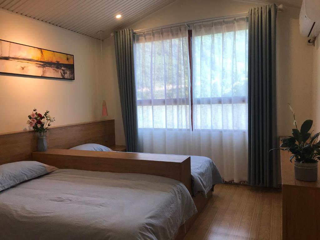 Postel nebo postele na pokoji v ubytování Enshi Grand Canyon Chunlun Farmstay