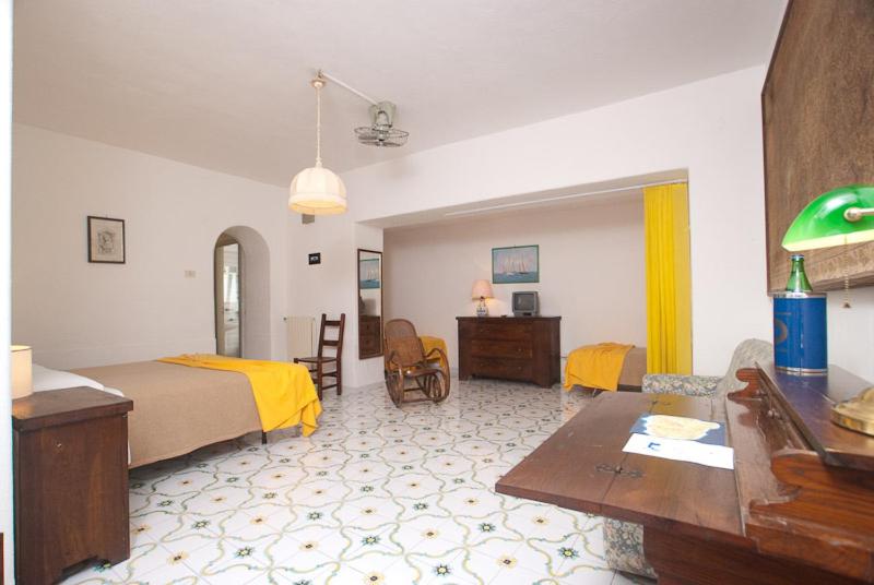a hotel room with a bed and a desk at Hotel Belsole in Ischia