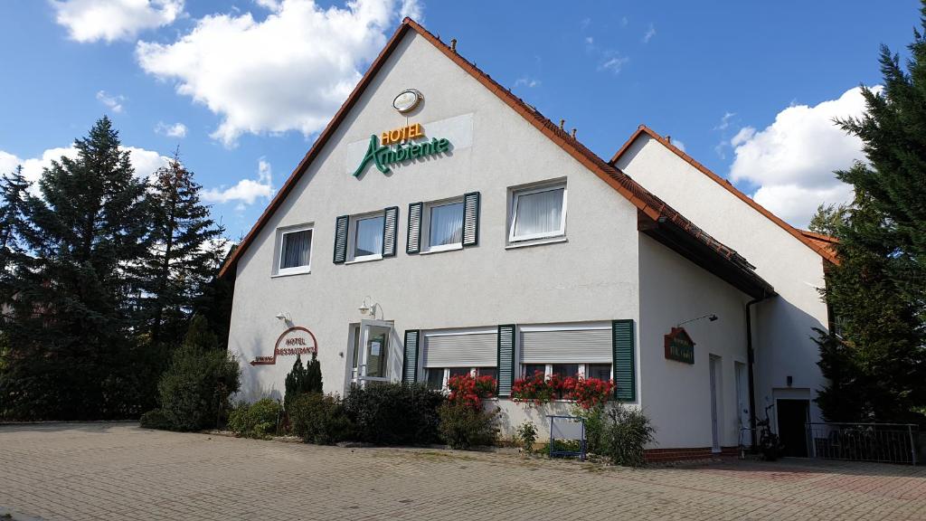 a white building with a sign on the side of it at Ambiente Hotel garni in Plauen
