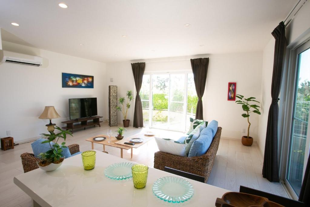 a living room with a couch and a table at Airy House I / Vacation STAY 46400 in Onna