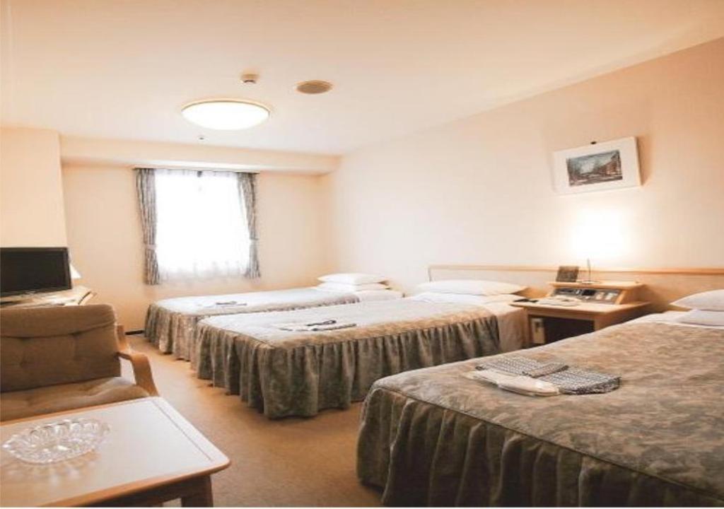 Un pat sau paturi într-o cameră la Narita U-City Hotel / Vacation STAY 42514