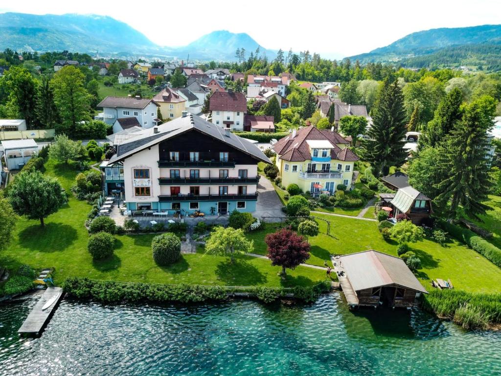 an aerial view of a house on an island in the water at Seepension Smoley in Villach