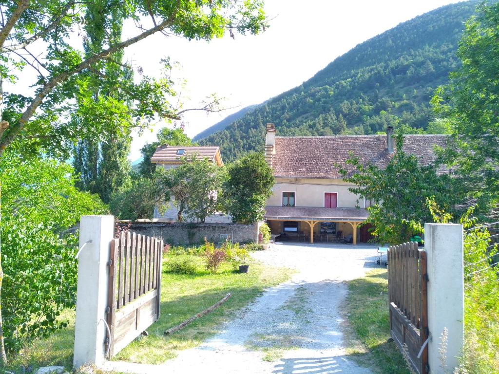 a gate in front of a house with a fence at le Mas du lac - spa et détente in Monestier-dʼAmbel