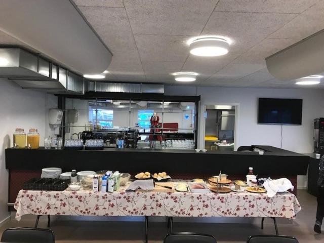 a table with food on it in a kitchen at Hotel Nuka in Ilulissat