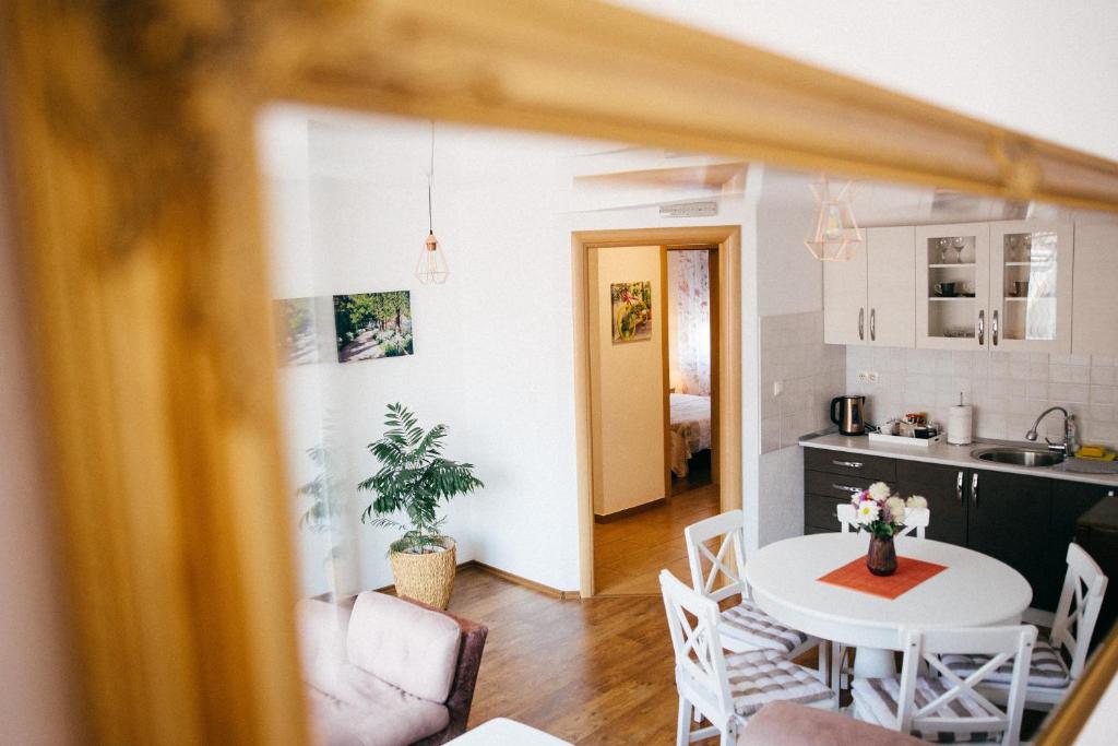 a kitchen and living room with a table and chairs at Lux Apartment I Prijedor in Prijedor