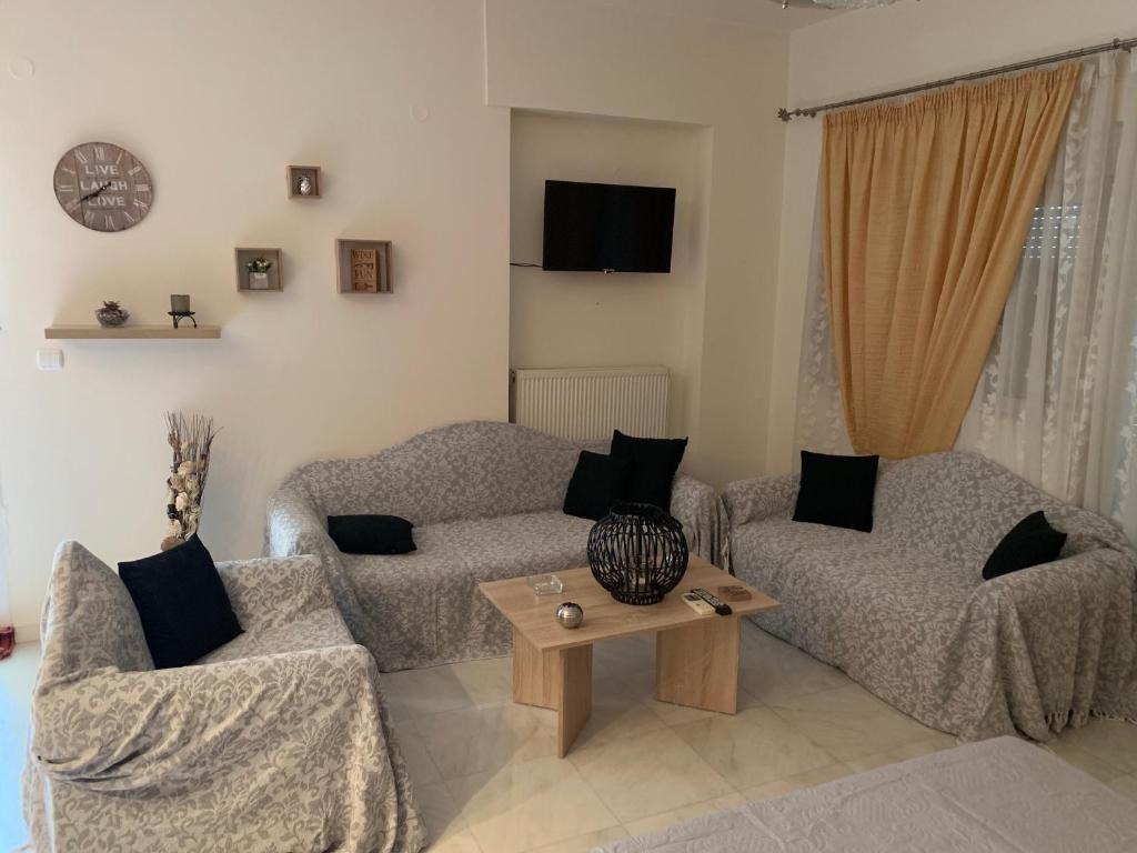 a living room filled with furniture and a tv at Danai's Loft in Heraklio