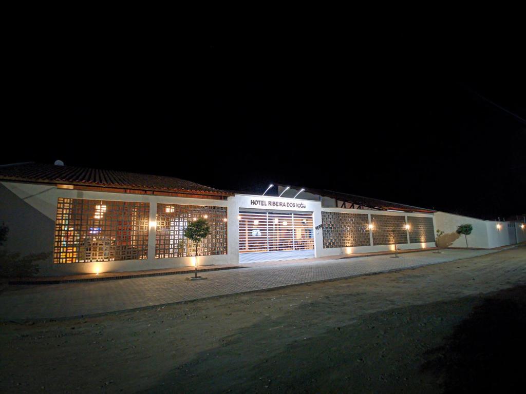 a building with lights on the side of it at night at Hotel Ribeira dos Icós in Icó