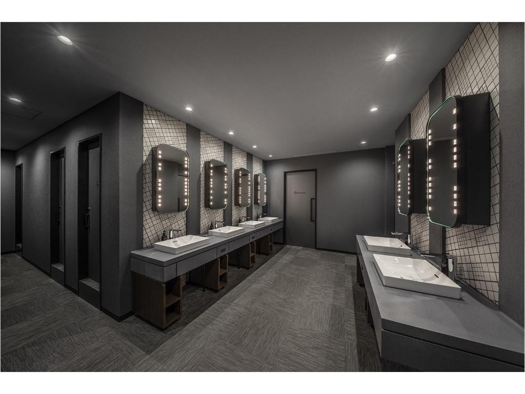 a bathroom with a row of sinks and mirrors at The Millennials Fukuoka in Fukuoka