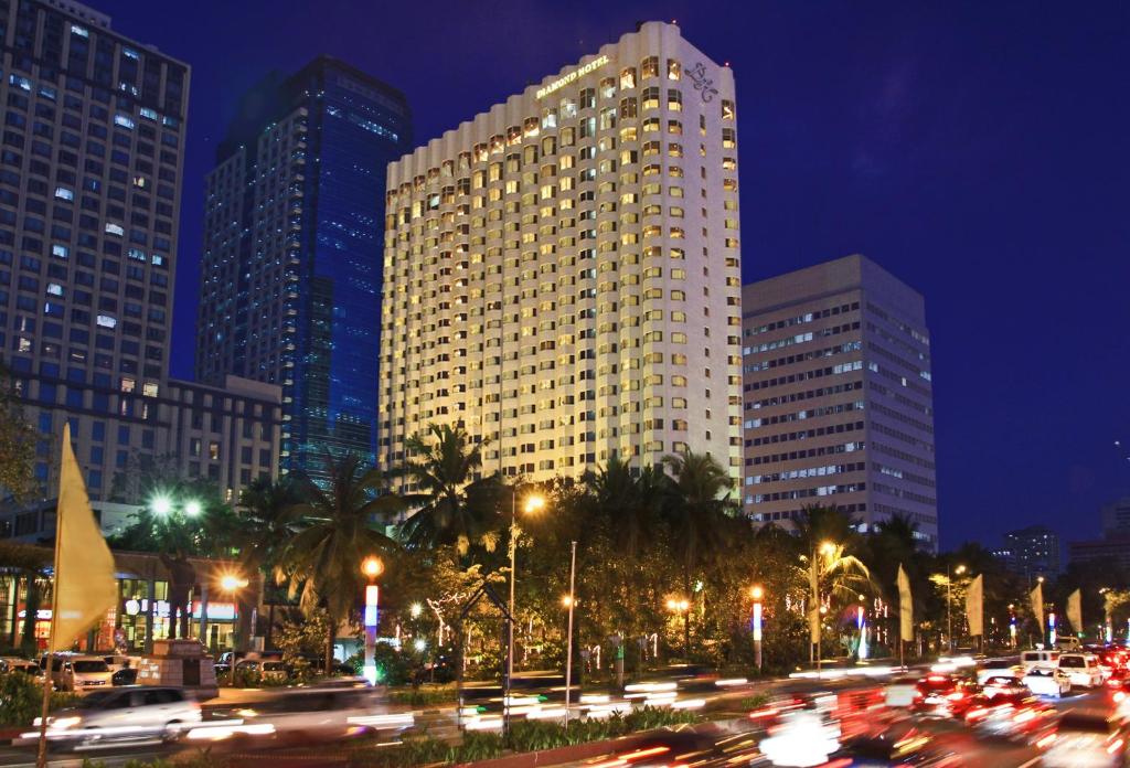 
a city street filled with lots of tall buildings at Diamond Hotel Philippines - Multiple Use Hotel in Manila
