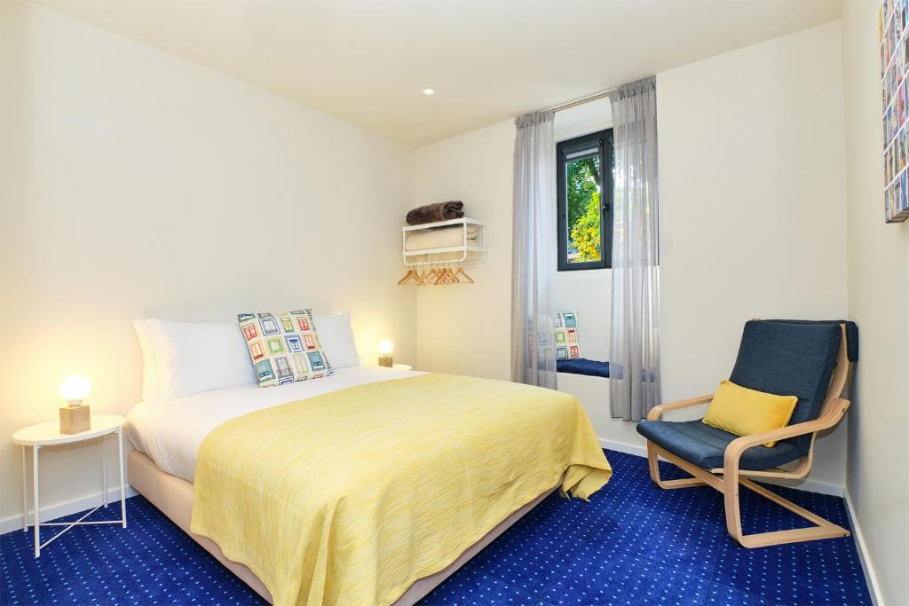 a bedroom with a bed and a chair at Sintra Bliss A Part in Sintra
