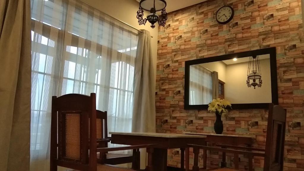 uno specchio su un muro di mattoni con un tavolo e una finestra di Homestay Lovebird a Wonosobo