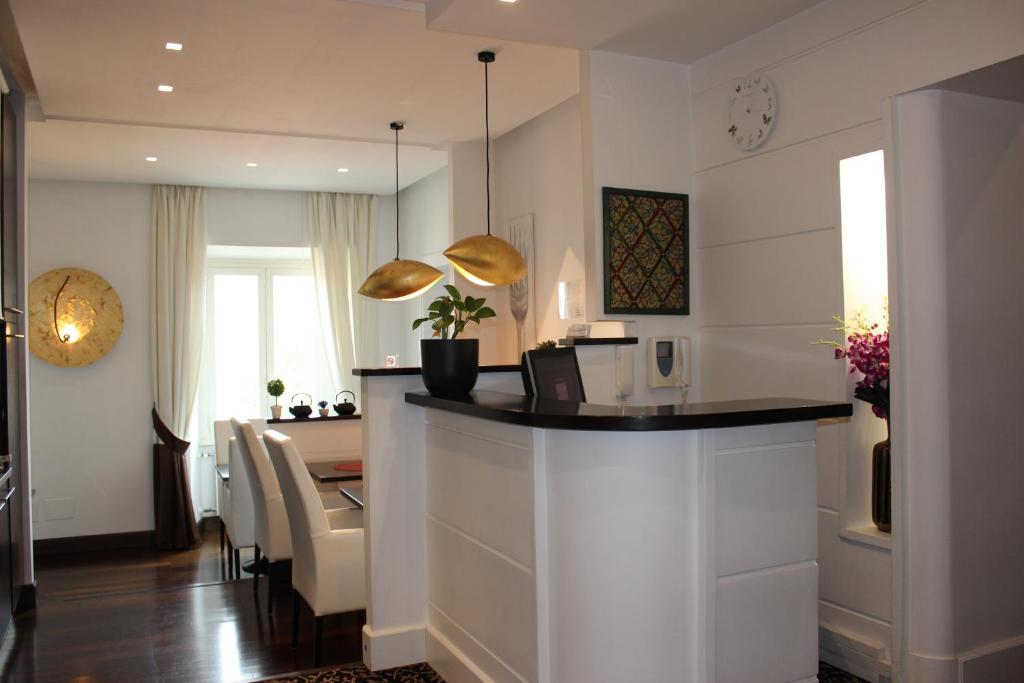 a kitchen with a counter and a dining room at Relais La Maison De Luxe in Rome