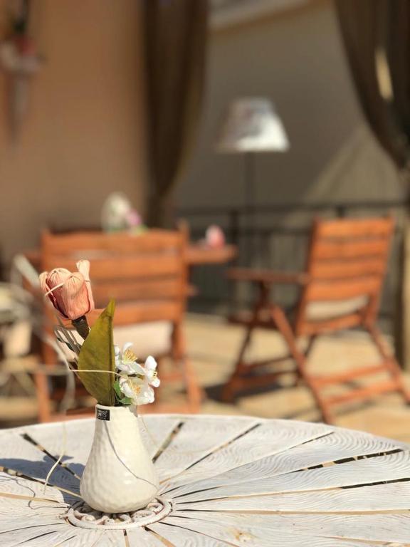 a vase filled with flowers sitting on a table at Villa La dame blanche in Skala Potamias