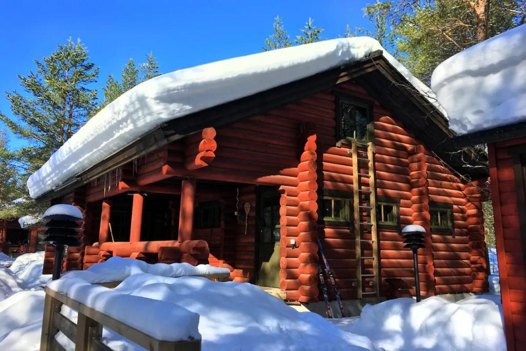 uma cabana com neve no telhado em Laavu Holiday Homes em Pelkosenniemi