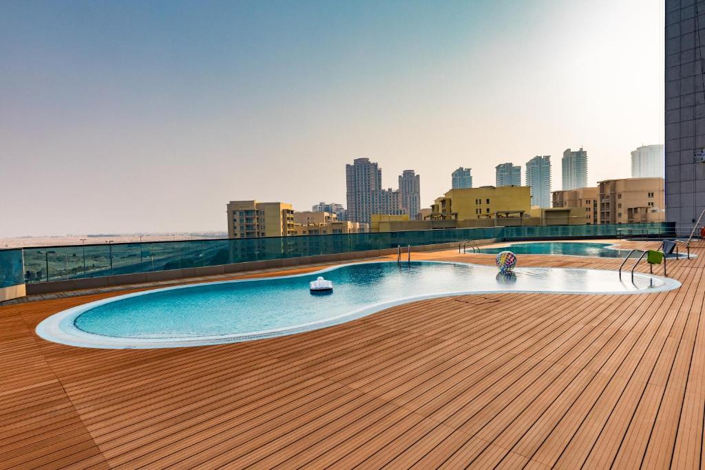 a swimming pool on the roof of a building at Millennium Place Barsha Heights Hotel Apartments in Dubai