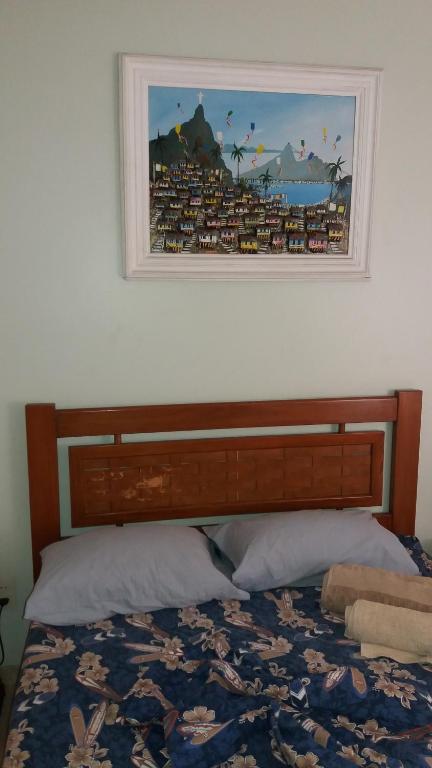 una camera con un letto con una foto sul muro di Paradise Room a Rio de Janeiro