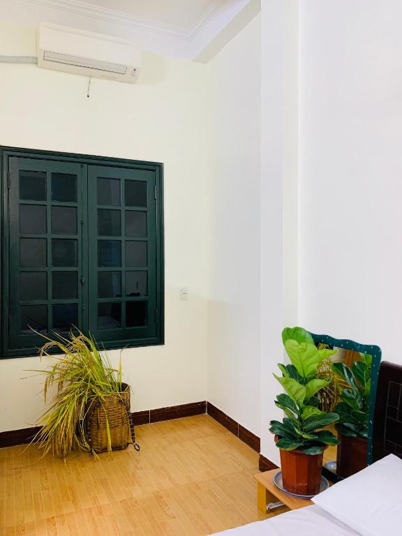 a room with a window and some plants in it at Be's Home & Tours in Ha Giang