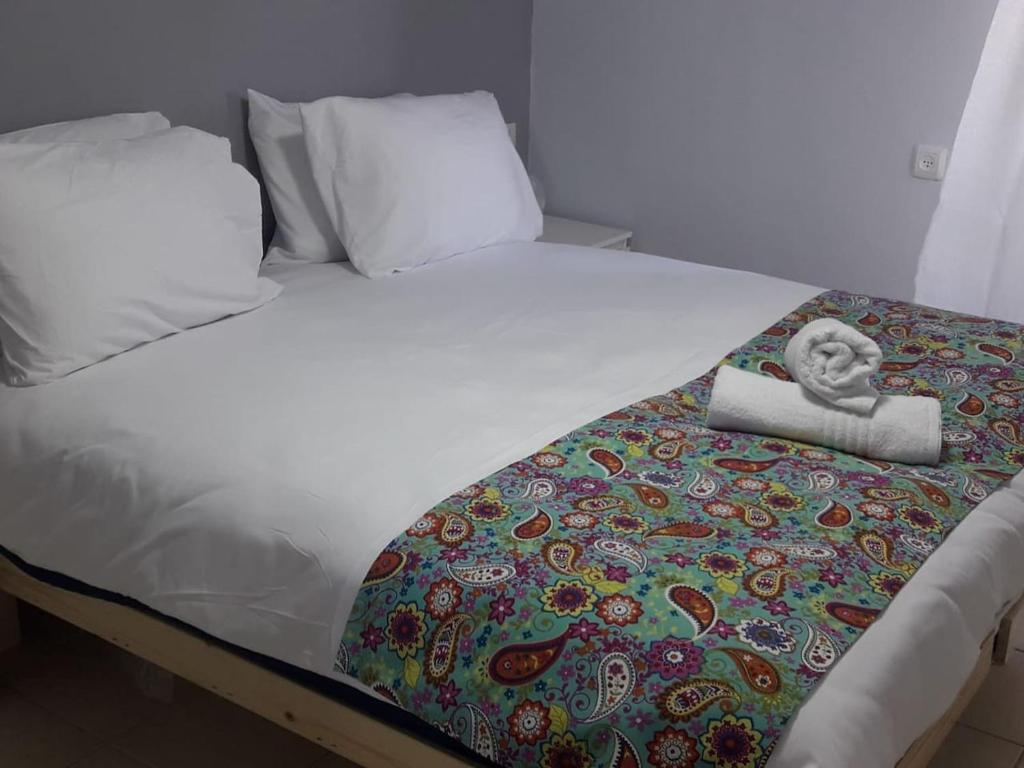 a white bed with a blanket with a head on it at Yaeli's Yam Souf in Eilat