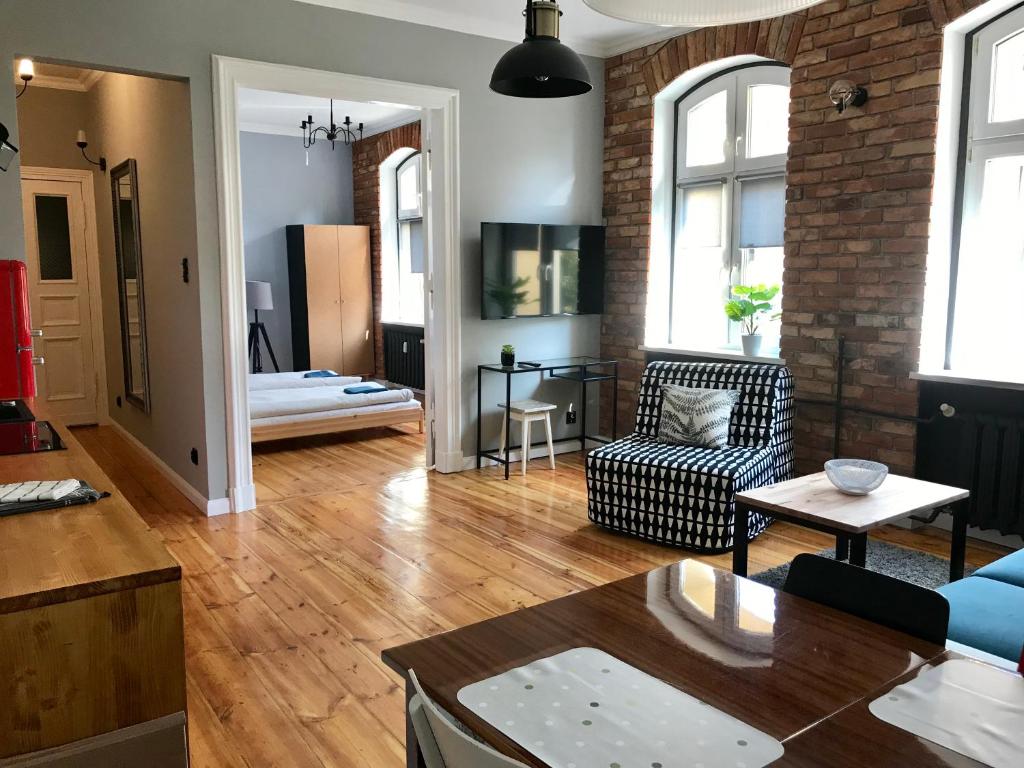 a living room with a couch and a table at Apartament Odrzanka in Gryfino