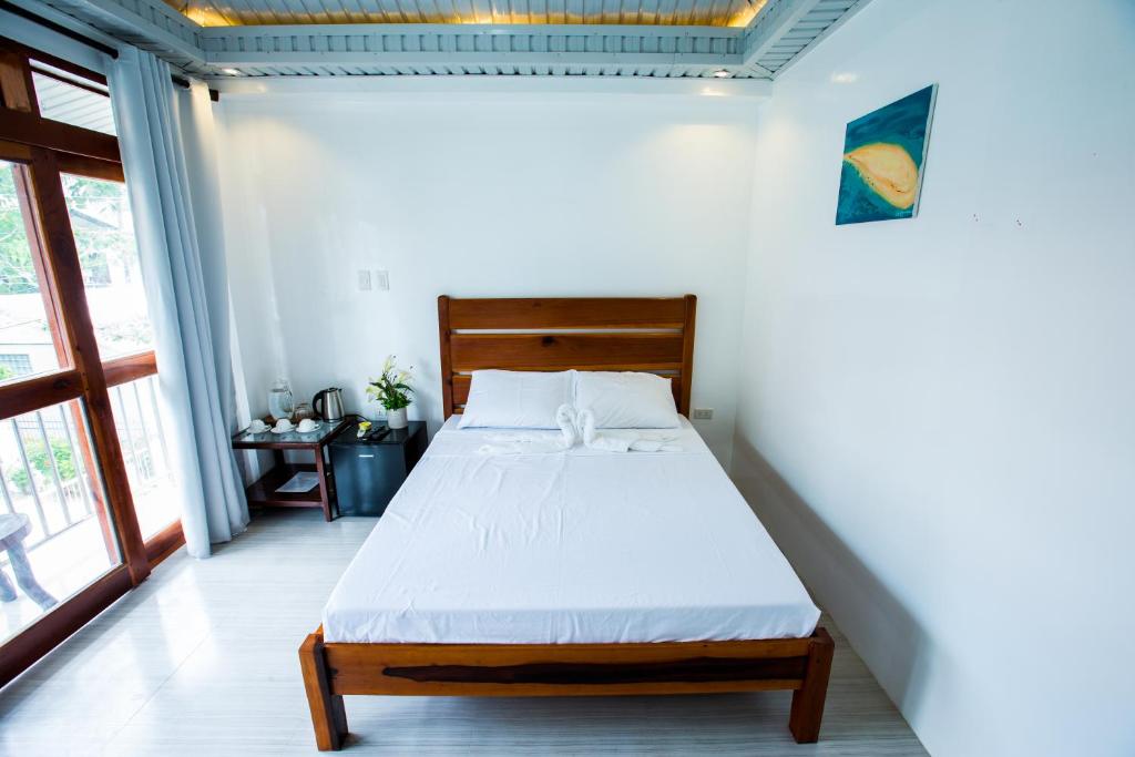 Postel nebo postele na pokoji v ubytování Siargao Home Sweet Home