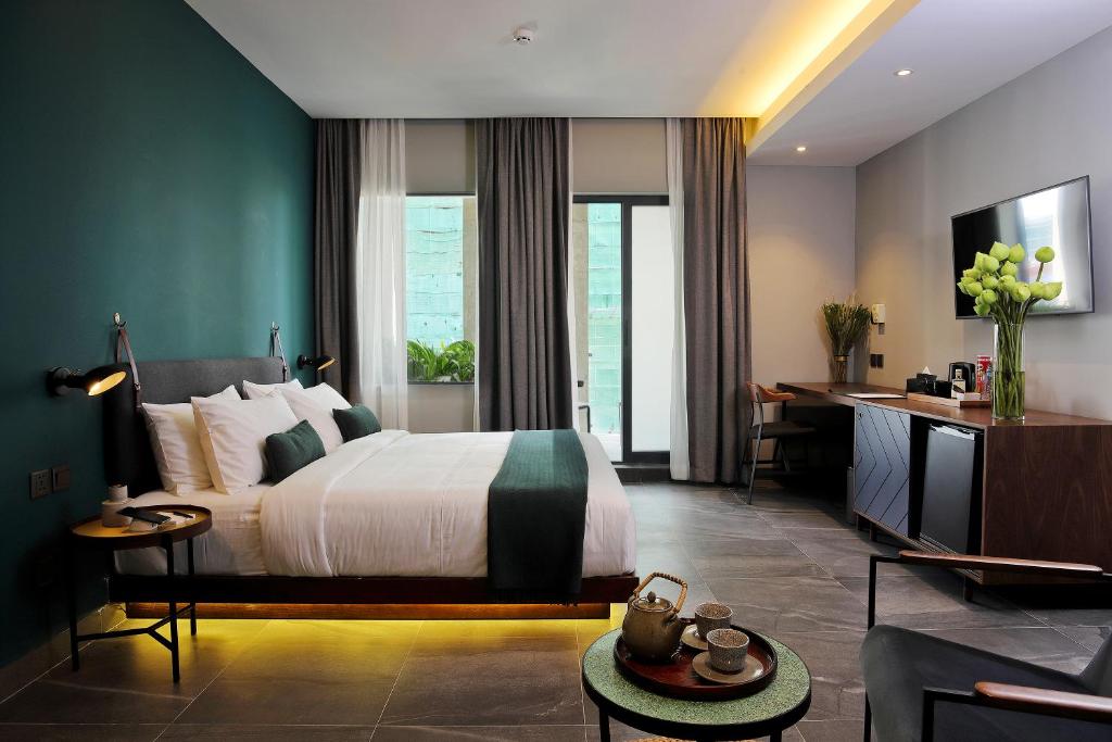 Postel nebo postele na pokoji v ubytování Baitong Hotel & Resort Phnom Penh