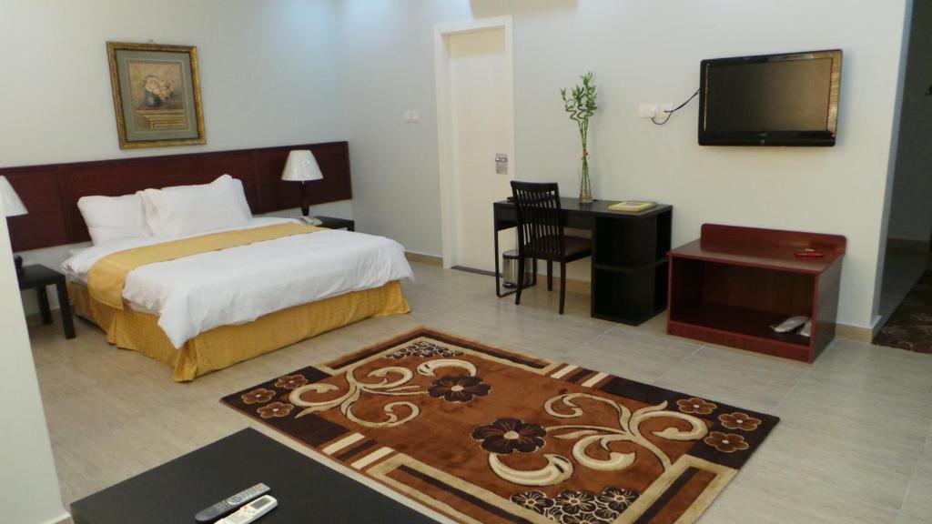 Postel nebo postele na pokoji v ubytování Al Dar Inn Hotel Apartment