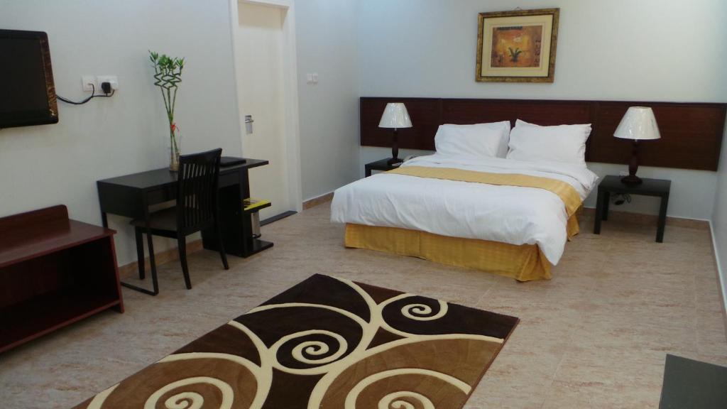 Postel nebo postele na pokoji v ubytování Al Dar Inn Hotel Apartment