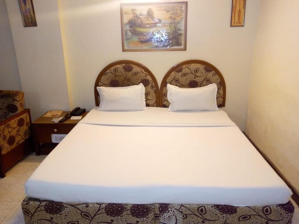 Postel nebo postele na pokoji v ubytování Hotel Ganga Ratan