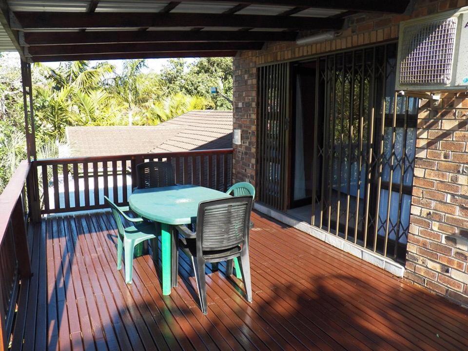 a patio with a table and chairs on a deck at 26 Pelser Plaat Meerensee in Richards Bay