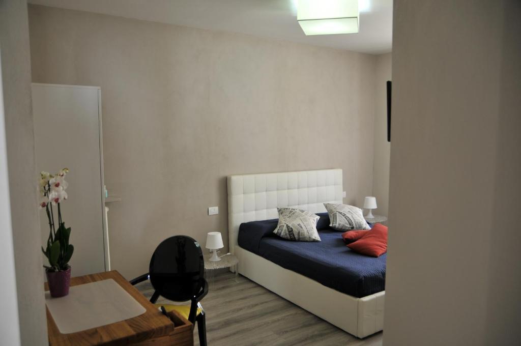 a bedroom with a bed and a desk and a chair at Civico51 in San Damiano dʼAsti