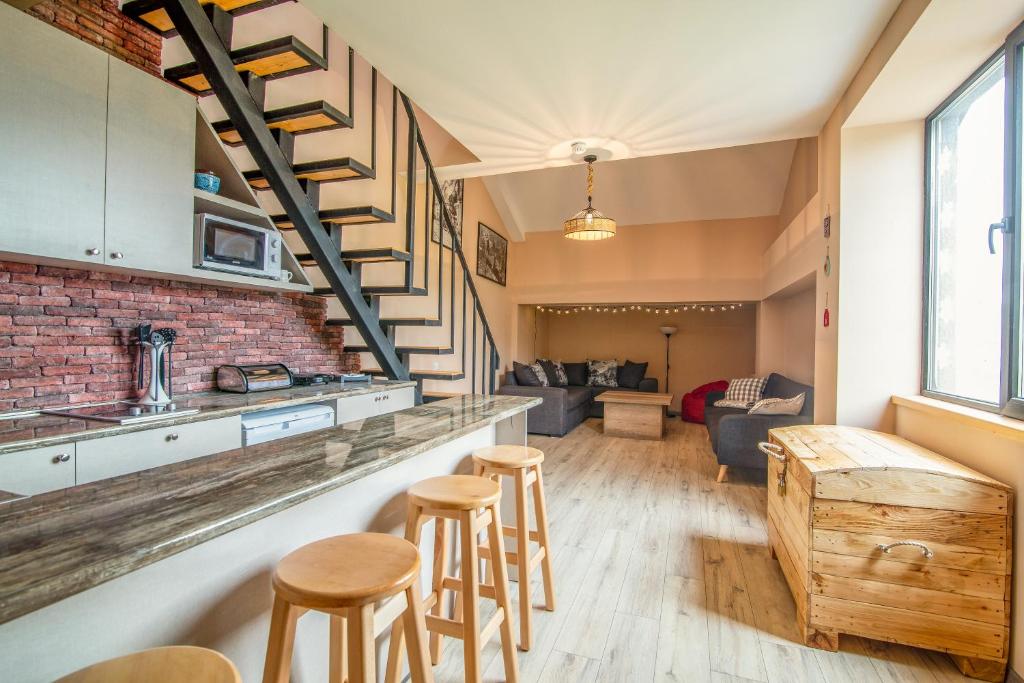 a kitchen and living room with a brick wall at Duplex in New Gudauri, block 4 in Gudauri