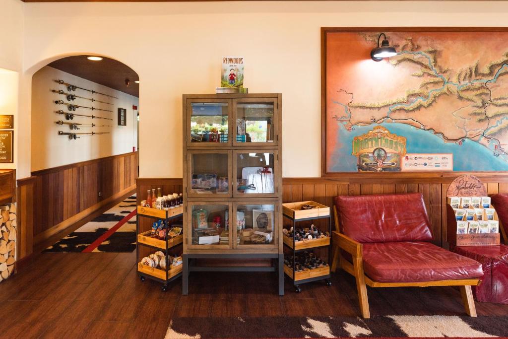 a waiting room with a red couch and a shelf at The Redwood Riverwalk, a boutique hotel in Fortuna