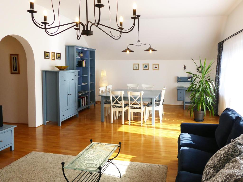 a living room with a table and a dining room at Apartment Galerija in Radovljica