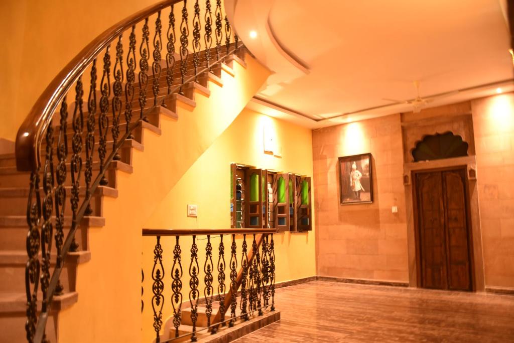 a hallway with a spiral staircase in a house at Jodhpur Palace Guest House in Jodhpur