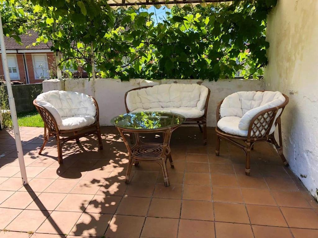 un patio con 2 sedie, un tavolo e 2 sedie di El Rincón de El Montán ad Avilés