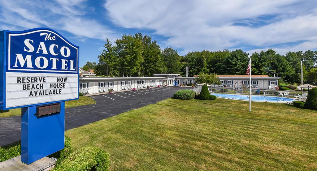 a motel sign in front of a parking lot at The Saco Motel in Saco