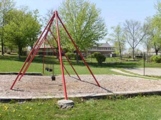 a red swing set in a park at Round Top Two-Bedroom Cottage 8 in Gettysburg