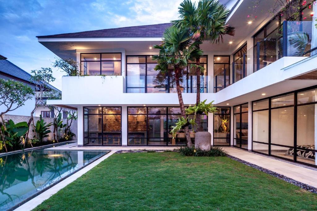 an exterior view of a house with a swimming pool at Villa Nonnavana - 12-minute walk to Batu Bolong Beach in Canggu