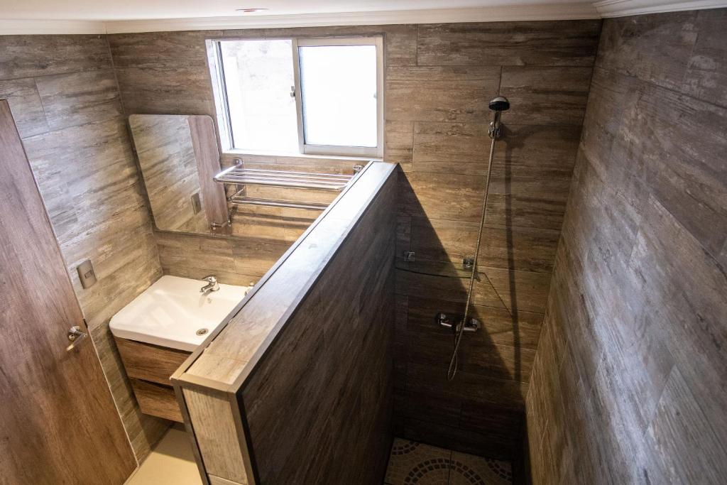 a bathroom with a sink and a window at Inaki Uhi Hotel in Hanga Roa