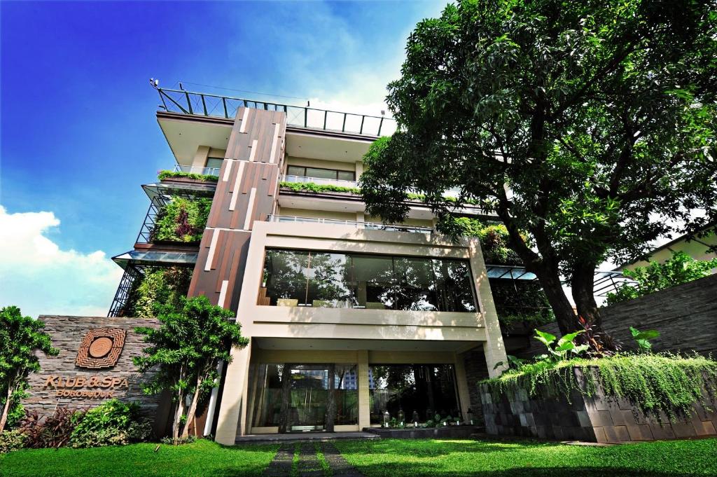 a tall building with a tree in front of it at Hotel Borobudur Jakarta in Jakarta