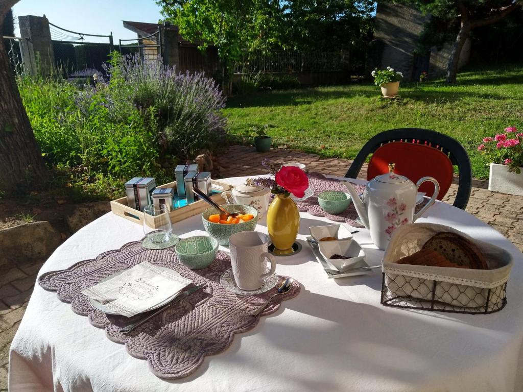 a table with a white table cloth and food on it at Les Bessonnes in Saint-Georges-Haute-Ville