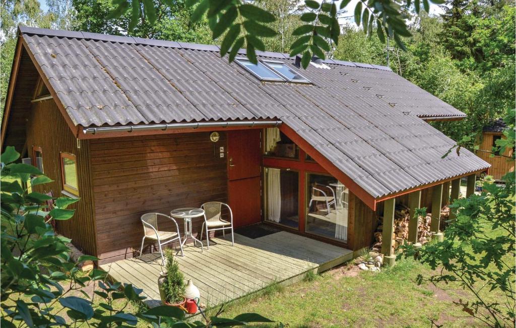 a small cabin with a deck and two chairs at Lovely Home In Vejby With Wifi in Vejby