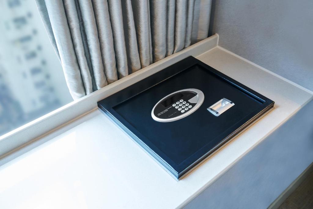 a box with a remote control sitting on a window sill at Hotel Ease Mong Kok in Hong Kong