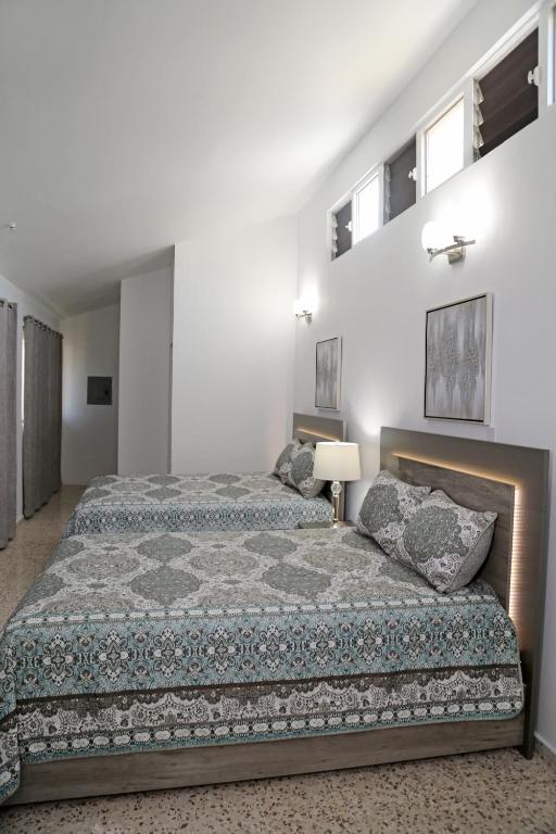 Postel nebo postele na pokoji v ubytování Itza-Bella Suites