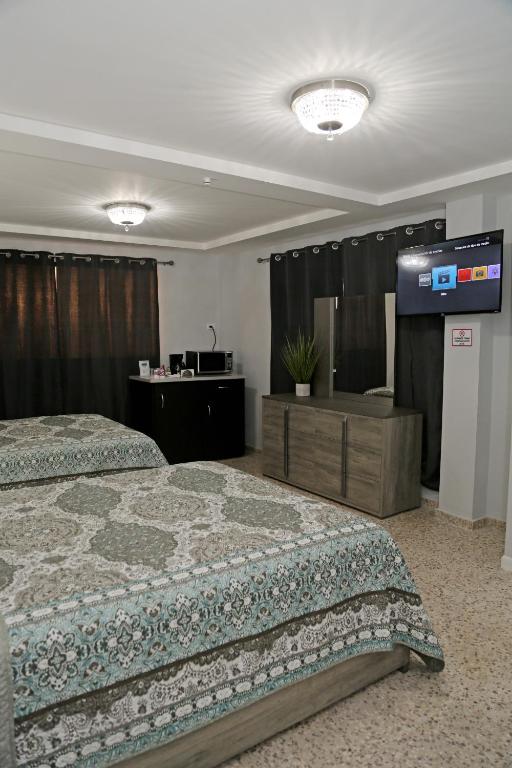 Postel nebo postele na pokoji v ubytování Itza-Bella Suites